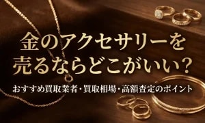 木製の台の上に並べられた金のネックレスや指輪、バングルを背景に、「金のアクセサリーを売るならどこがいい？」「おすすめ買取業者・買取相場・高額査定のポイント」と書かれた画像。